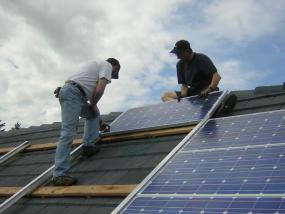 Workers installing solar panels